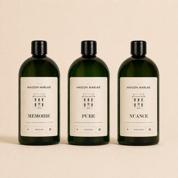 The three bottles, MÉMOIRE, PURE and NUANCE, on a cream background