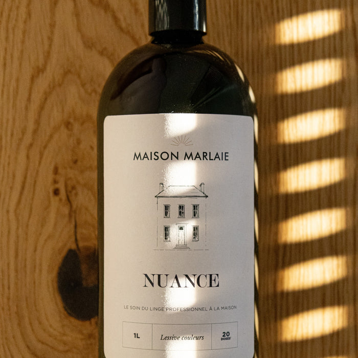 Maison Marlaie NUANCE bottle in the light on a wooden panel